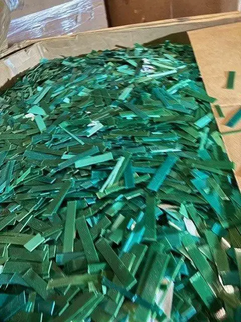 A box of chopped green PET strapping
